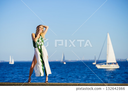 Fashion woman against yachts on sea 132642866