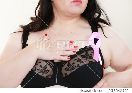 Woman chest in bra, pink cancer ribbon 132642901
