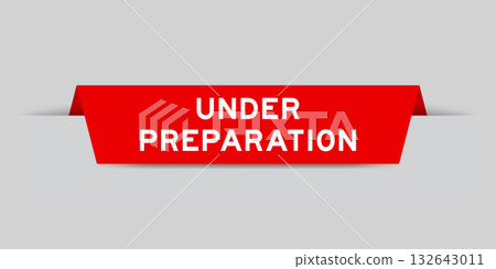 Red color inserted label with word under preparation on gray background Red color inserted label with word under preparation on gray background 132643011