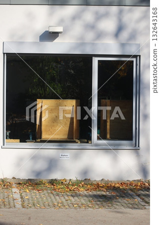 Window with a wooden box on the sill Window with a wooden box on the sill 132643168