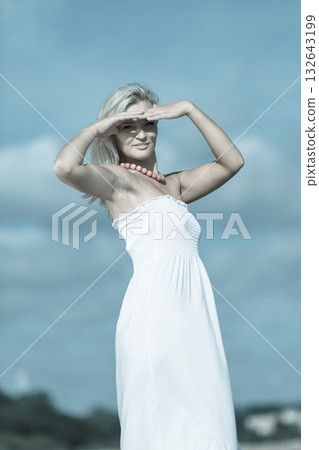 Young lady resting on beach. 132643199