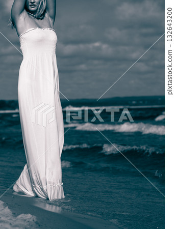 Young lady resting on beach. 132643200