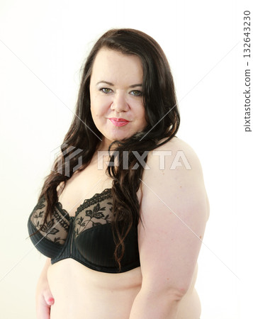 Woman in black bra showing her breast chest. 132643230