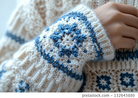 Eco-friendly craft. Trending in fashion. Crochet details of snowflakes pattern on a modern garment. Winter atmosphere in clothes. Eco-friendly craft. Trending in fashion. Crochet details of snowflakes pattern on a modern garment. Winter atmosphere in clothes. 132643880