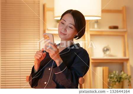 woman looking at smartphone at night woman looking at smartphone at night 132644164