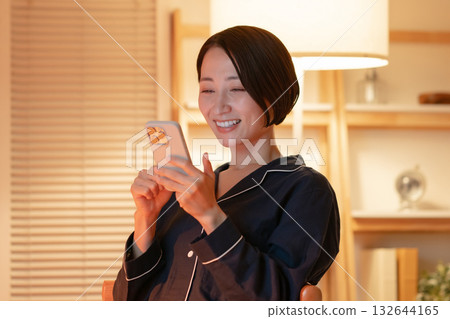 woman looking at smartphone at night woman looking at smartphone at night 132644165