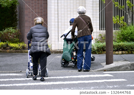 Yokohama cityscape in Japan: Aging society (an elderly woman going shopping. There is also a man in a wheelchair on the street...) = Yokohama city 132644768