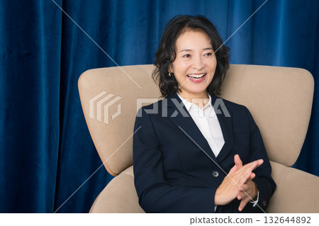 A middle-career woman confidently talking about business A middle-career woman confidently talking about business 132644892