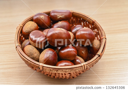 Raw chestnuts in a basket 132645306