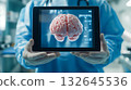 Doctor holding human brain on screen of tablet. 132645536