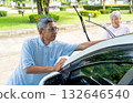 Asian senior man use car towel to clean his car with senior woman and look happiness in front of their house. 132646540
