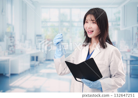Young woman working with chemicals in test tubes in a laboratory 132647251
