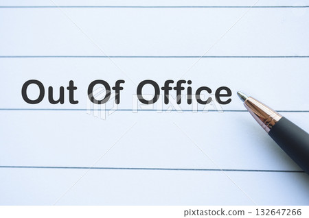 Out of office text on yellow notepad with on white notebook. Getaway or on a vacation concept. Out of office text on yellow notepad with on white notebook. Getaway or on a vacation concept. 132647266