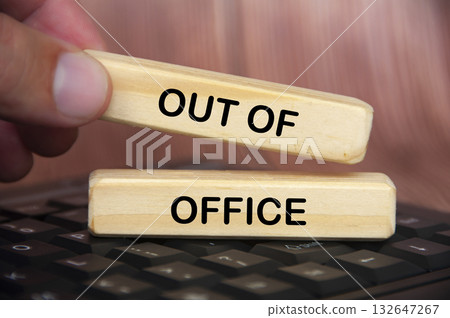 Hand placing out of office text on wooden blocks. Getaway or on a vacation concept. Hand placing out of office text on wooden blocks. Getaway or on a vacation concept. 132647267