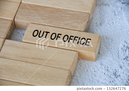 Out of office text on wooden block separated from the rest. Getaway or on a vacation concept. Out of office text on wooden block separated from the rest. Getaway or on a vacation concept. 132647276