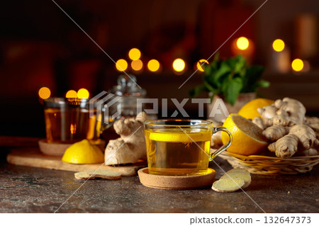 Cup of ginger tea with lemon, honey, mint, and ginger root. Cup of ginger tea with lemon, honey, mint, and ginger root. 132647373