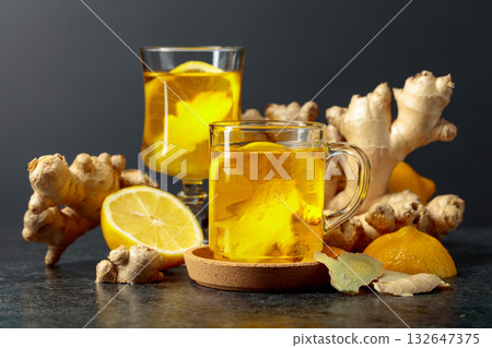 Ginger tea with lemon on a black background. Ginger tea with lemon on a black background. 132647375