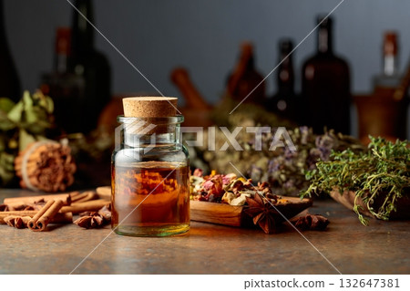 Essential herbal tincture in a small glass bottle. 132647381