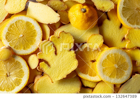 Close-up of fresh ginger and lemon slices. 132647389