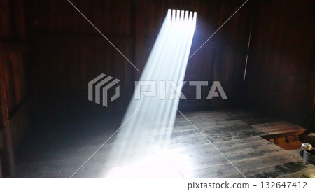 Sunlight streaming straight through the lattice window of an old house (2944) 132647412