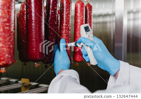 Smoked sausage production line in the factory 132647444