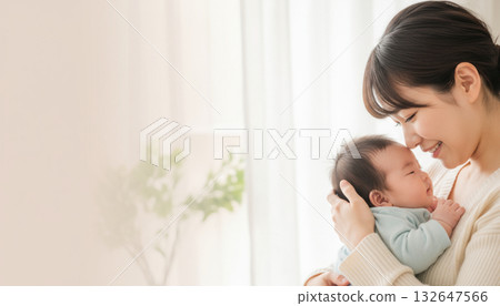 A young mother and her baby face to face against a white background lit by soft sunlight 132647566
