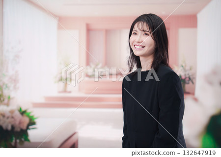 Young woman wearing mourning clothes and holding prayer beads at a funeral Young woman wearing mourning clothes and holding prayer beads at a funeral 132647919