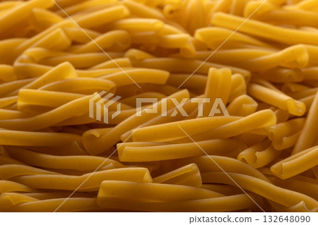 Uncooked Casarecce Pasta, Close-Up View of Italian Food Texture Uncooked Casarecce Pasta, Close-Up View of Italian Food Texture 132648090