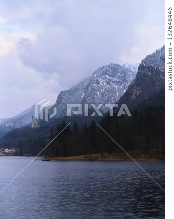 Snow-capped mountains and serene lake landscape in a tranquil setting during winter 132648446