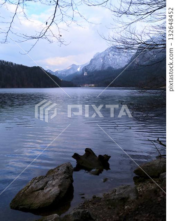 Tranquil lake view with mountains and reflections during early morning 132648452