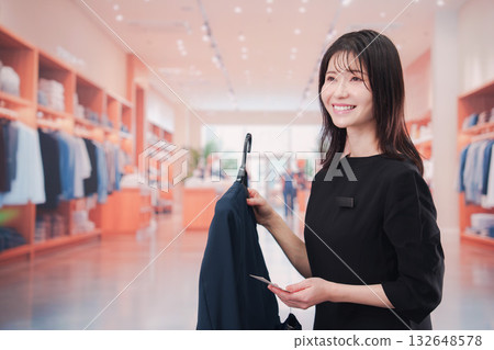 A young female staff member working at an apparel store 132648578