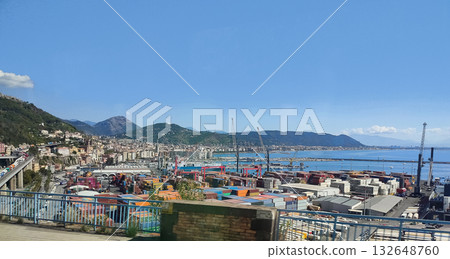 Salerno, Italy - Container ships, stacked cargo and cranes at the industrial port of Salerno, with trucks parked at the container terminal in front. Salerno, Italy - Container ships, stacked cargo and cranes at the industrial port of Salerno, with trucks parked at the container terminal in front. 132648760