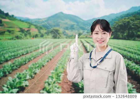 A young farmer woman working in a large farm 132648809