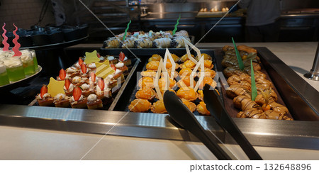 Dining Room Buffet aboard the abstract luxury cruise ship. Selective focus. Sweet cakes Dining Room Buffet aboard the abstract luxury cruise ship. Selective focus. Sweet cakes 132648896