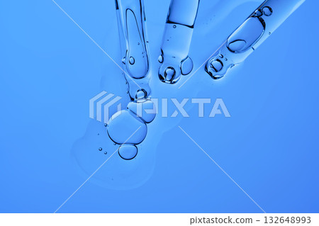 Pipettes with facial serum or other cosmetic product on a blue background. 132648993