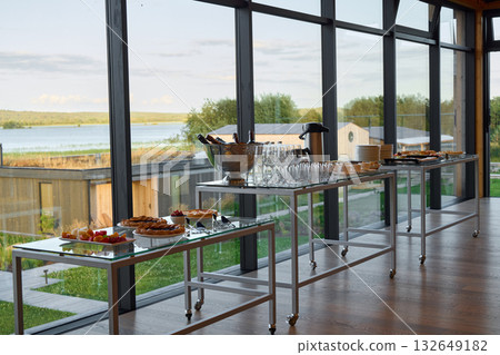 An Elegant Catering Setup that Features a Scenic View Overlooking the Water and Nature 132649182