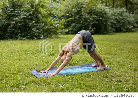 A person engaged in practicing a yoga pose amidst the beautiful natural surroundings 132649185
