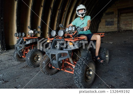 Experience an exhilarating and adventurous ATV ride through an abandoned warehouse setting 132649192