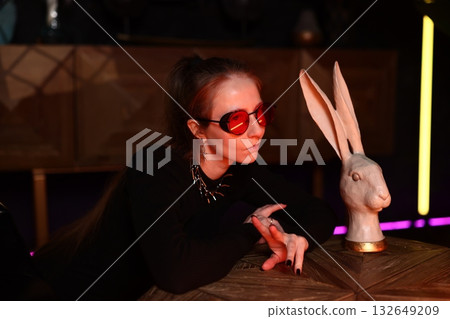 festive night sculpture, joyful nighttime scene featuring woman and rabbit sculpture celebration festive night sculpture, joyful nighttime scene featuring woman and rabbit sculpture celebration 132649209