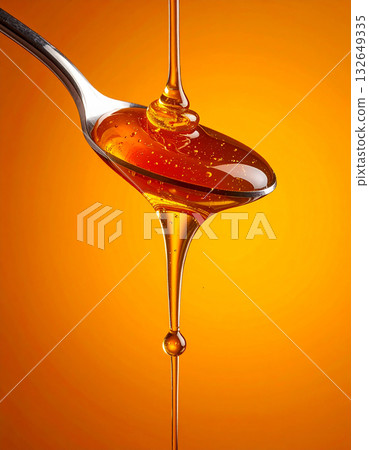 Sweet bliss of honey dipper and honeycomb dripping with honey on an orange background 132649335