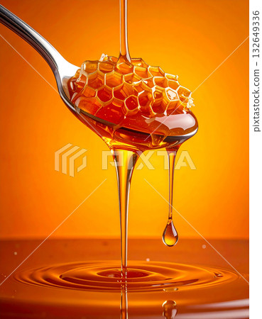 Sweet bliss of honey dipper and honeycomb dripping with honey on an orange background 132649336
