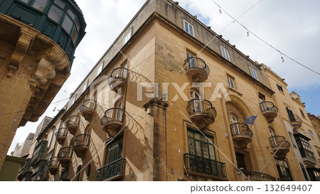 View of old building with windows, balconies in city. Republic of Malta, the picturesque city of Valetta, Malta. View of old building with windows, balconies in city. Republic of Malta, the picturesque city of Valetta, Malta. 132649407