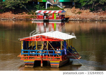 Non motorized ferry, called planchon, used by residents to cross the Sinu River from one bank to the other in the city of Monteria, Colombia. Non motorized ferry, called planchon, used by residents to cross the Sinu River from one bank to the other in the city of Monteria, Colombia. 132649935