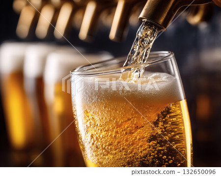 The moment when foamy draft beer is poured from the beer server 132650096
