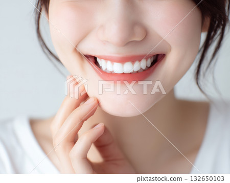 Close-up portrait of a beautiful Japanese woman smiling with white teeth 132650103