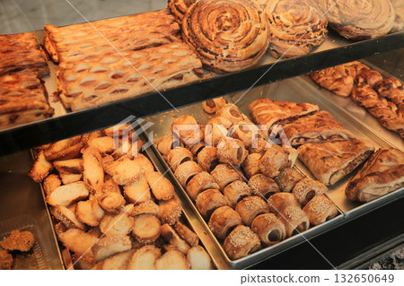 Selection of sweet and savory pastries, rolls, and croissants in bakery showcase Selection of sweet and savory pastries, rolls, and croissants in bakery showcase 132650649