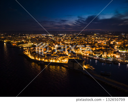 Night view of the illuminated historic center, harbor, and Carlo V Castle in Monopoli, Italy Night view of the illuminated historic center, harbor, and Carlo V Castle in Monopoli, Italy 132650709