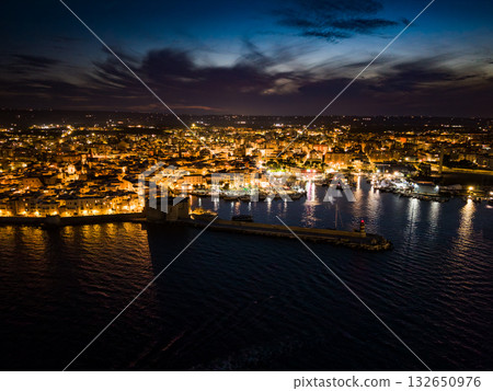 Iconic view of the illuminated historic center, harbor, and castle of Monopoli, Italy, at night Iconic view of the illuminated historic center, harbor, and castle of Monopoli, Italy, at night 132650976