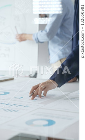 Professional team analyzing financial reports, sharing insights and planning strategic decisions in modern workplace setting. Business people concept Professional team analyzing financial reports, sharing insights and planning strategic decisions in modern workplace setting. Business people concept 132650981