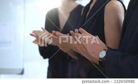 Group of business people clapping hands celebrating achievement, showing appreciation and support during a corporate meeting or seminar at a bright office conference 132650990